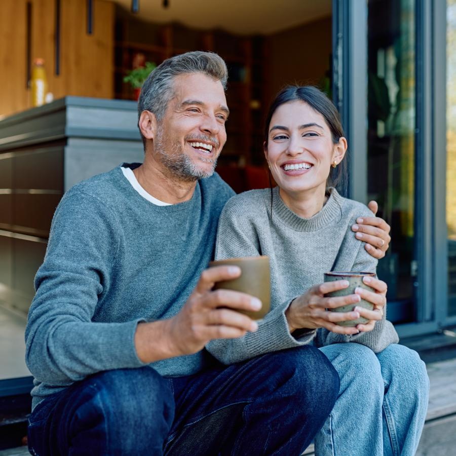 a man and a woman sitting on stairs and smiling
