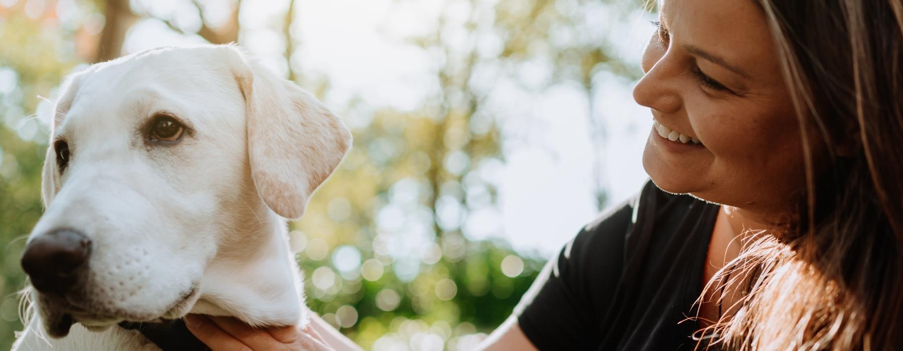 a woman petting a dog