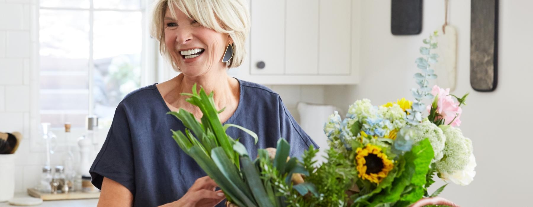 a woman holding a basket of flowers