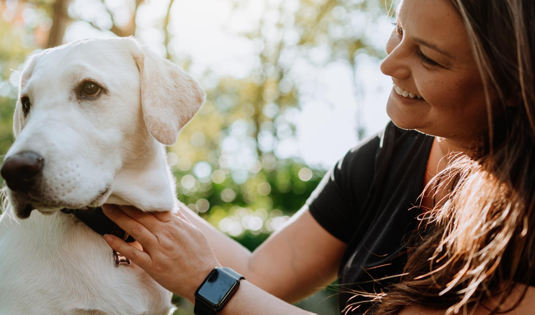 a woman petting a dog